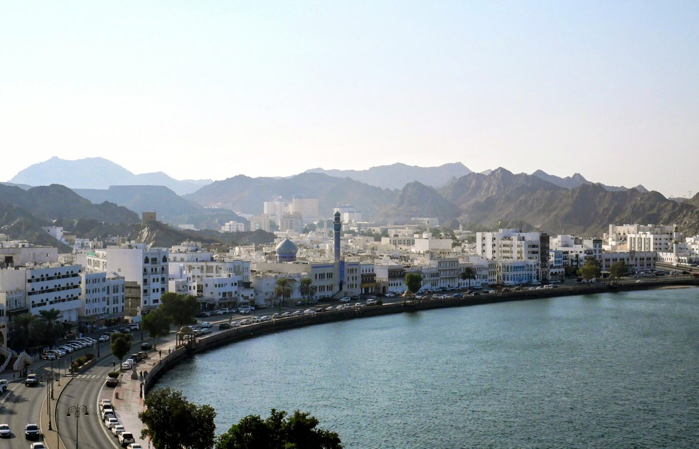 The Muttrah Corniche curving along Muscat harbour beneath the Al Hajar mountains