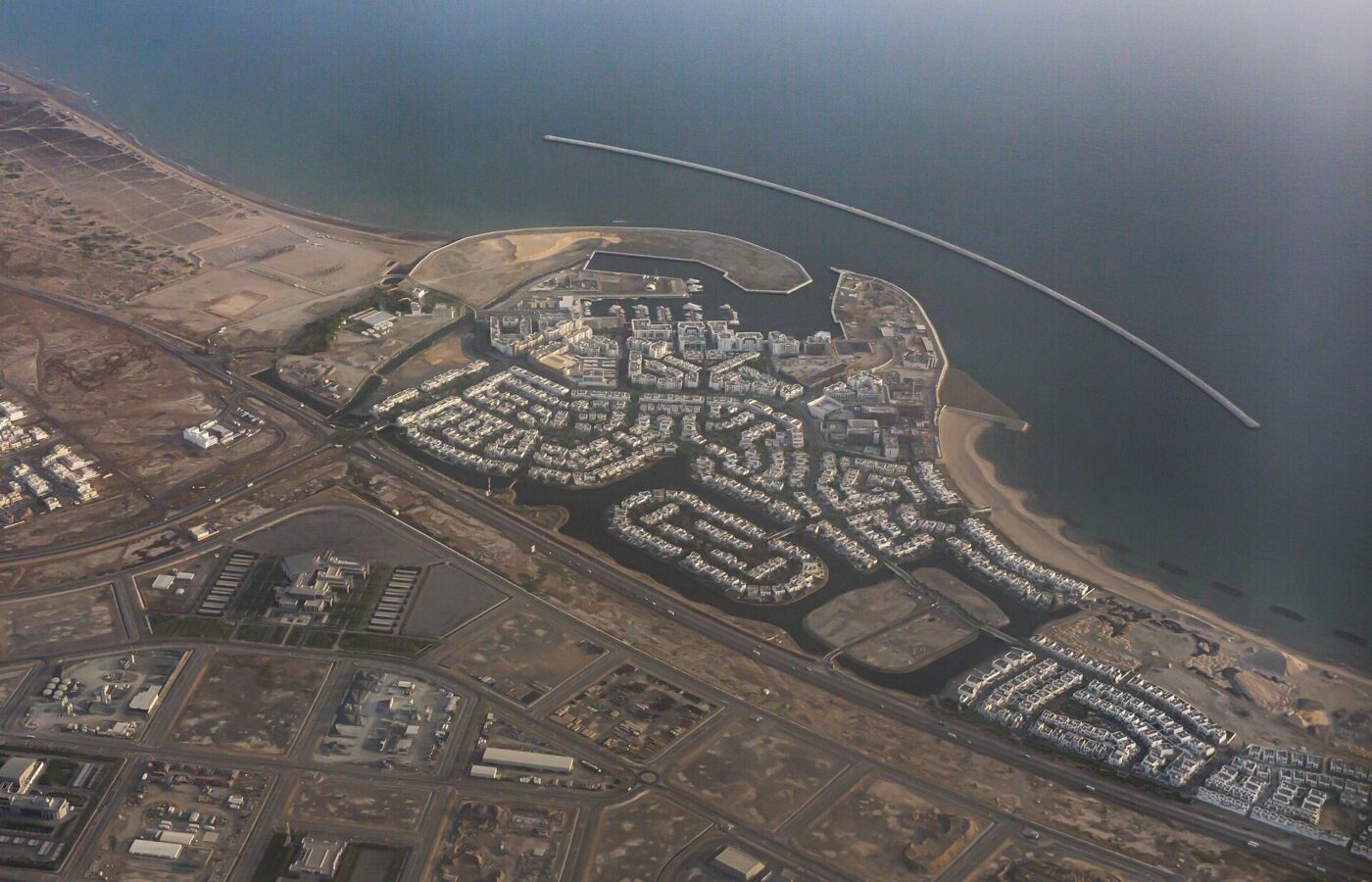 Aerial view of a planned coastal residential development near Muscat
