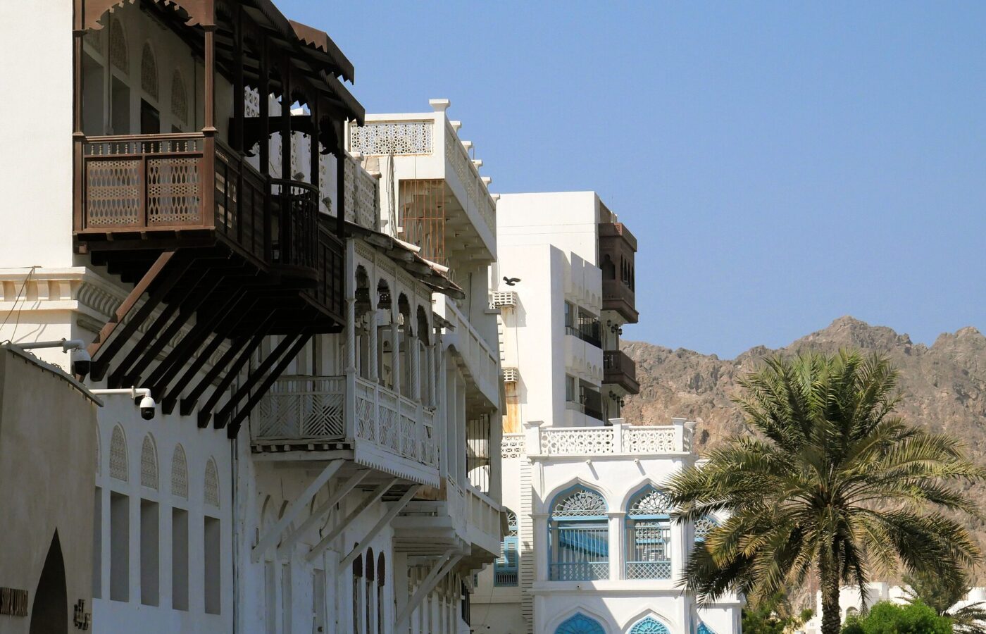 Carved wooden balconies on traditional whitewashed houses in Muttrah