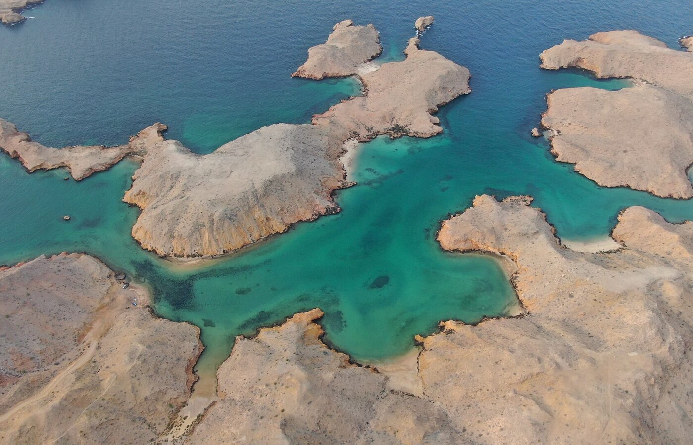 Turquoise coves and limestone inlets at Bandar Khayran near Muscat