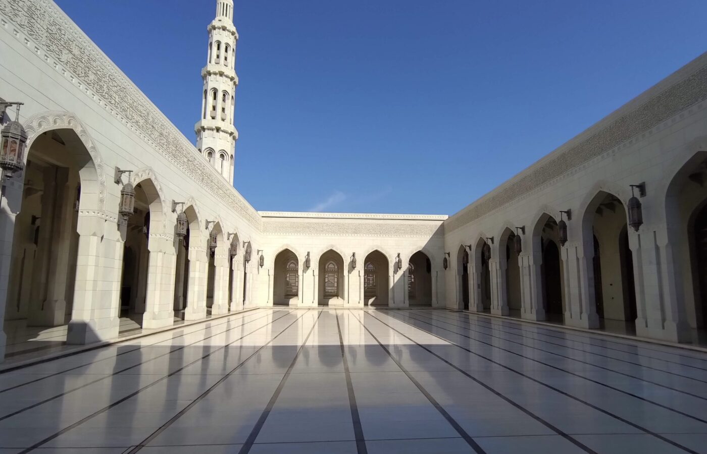 The arcaded courtyard and minaret of the Sultan Qaboos Grand Mosque, Muscat