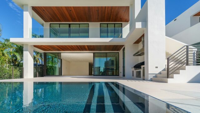 Grand white villa with a landscaped drive